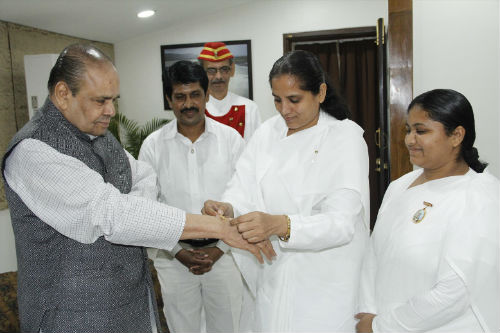 Governor of Maharastra HE Shankaraarayanan & Social Activist Anna Hajare being tied Rakhi by BK Sisters